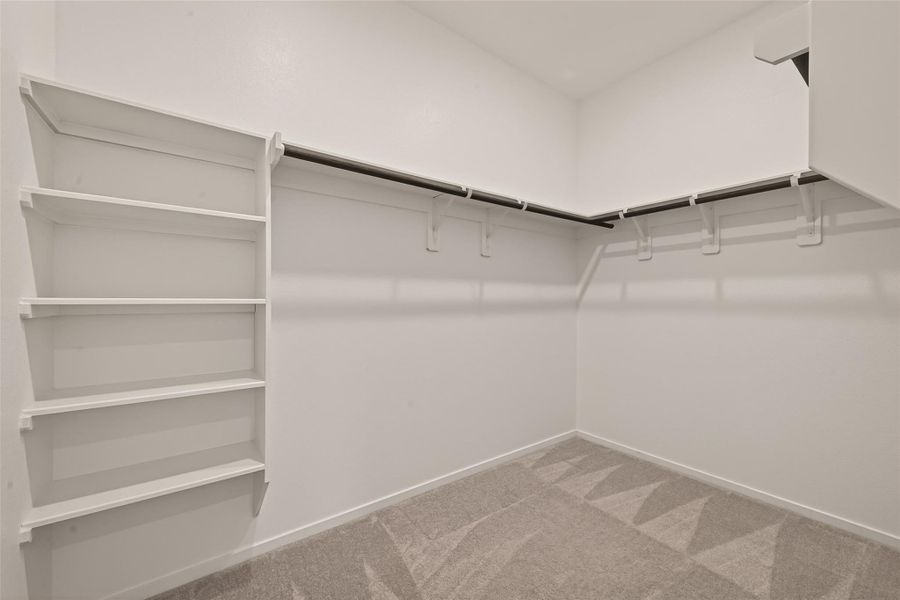 Large walk-in closet with built-in shelving and plenty of space to keep everything organized and easily accessible.