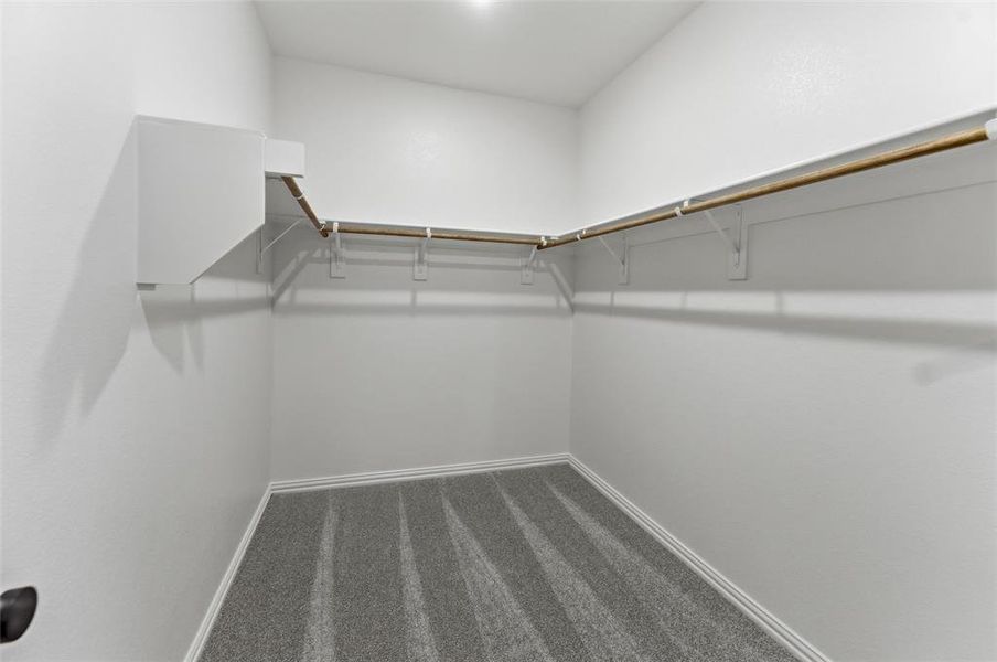Walk-in closet with integrated shelving and hanging rods