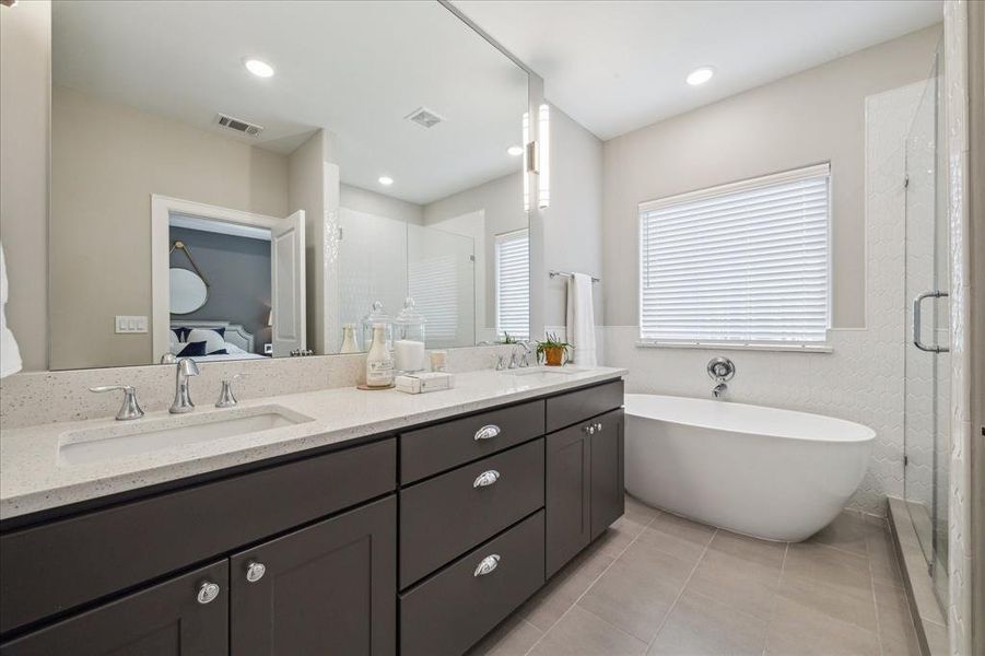 Primary en suite bath with dualvanities and separate soaking tub.