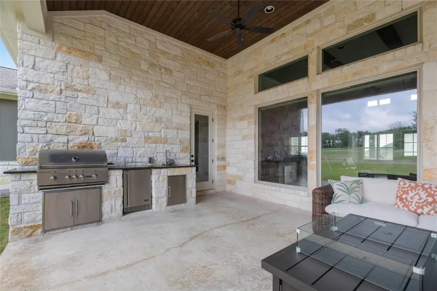 An inviting outdoor living area features a full kitchen and ample space for relaxation. An inviting outdoor living area features a full kitchen and ample space for relaxation.