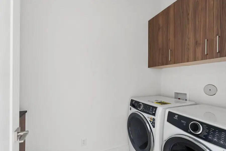 Convenient second-floor laundry with an Electrolux front-load washer and dryer, plus built-in counter space for folding. Convenient second-floor laundry with an Electrolux front-load washer and dryer, plus built-in counter space for folding.