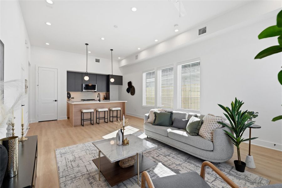 Open-concept duplex layout with seamless flow between the living area and kitchen, ideal for entertaining.