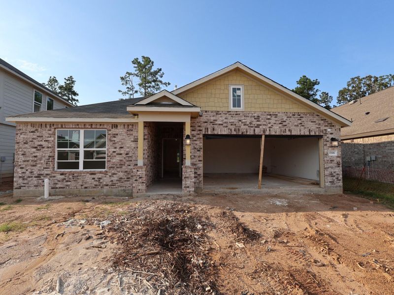 Front exterior of a new home in Pinewood at Grand Texas, New Caney, TX, highlighting curb appeal (Image 17).