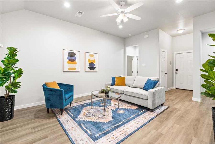 Living room with light wood-style floors, a ceiling fan, and recessed lighting Living room with light wood-style floors, a ceiling fan, and recessed lighting