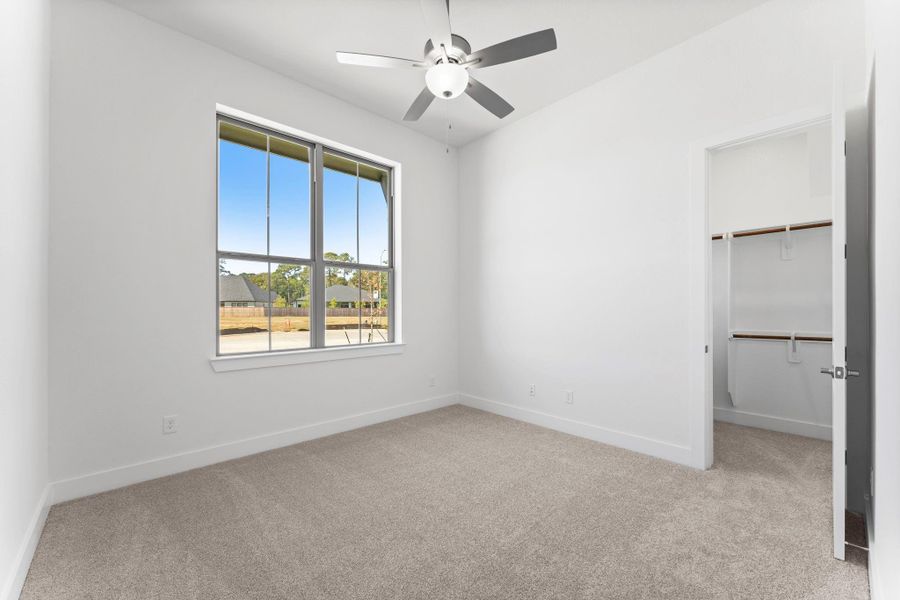 Bedroom 3 is located on the front of the home features a large walk-in closet. Bedroom 3 is located on the front of the home features a large walk-in closet.