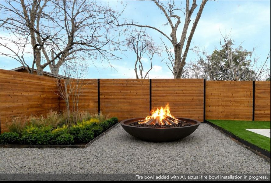 Fenced backyard featuring a fire pit and a patio area