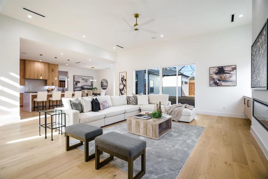 Living room featuring ceiling fan and light wood-type flooring