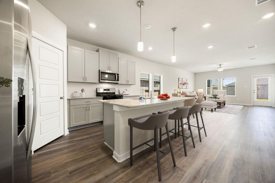 This kitchen is by far any chef’s dream! This spacious kitchen features a large kitchen island with added breakfast bar and pendant lighting, high ceilings, recessed lighting, grey stained wood cabinets, quartz countertops, SS appliances, modern tile backsplash, and a walk-in pantry all overlooking your huge family room. *Virtually Staged This kitchen is by far any chef’s dream! This spacious kitchen features a large kitchen island with added breakfast bar and pendant lighting, high ceilings, recessed lighting, grey stained wood cabinets, quartz countertops, SS appliances, modern tile backsplash, and a walk-in pantry all overlooking your huge family room. *Virtually Staged