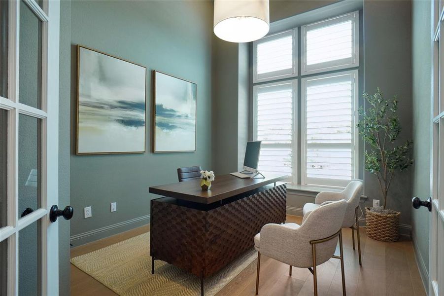 Home office featuring french doors and hardwood / wood-style floors