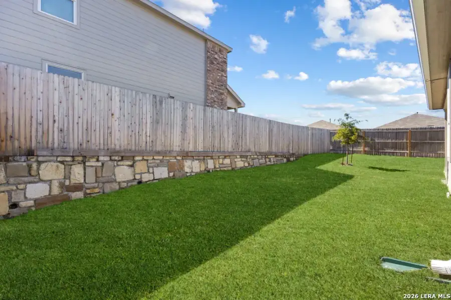 Exterior details and patio area of a home in Hightop Ridge, Converse (Image 31).