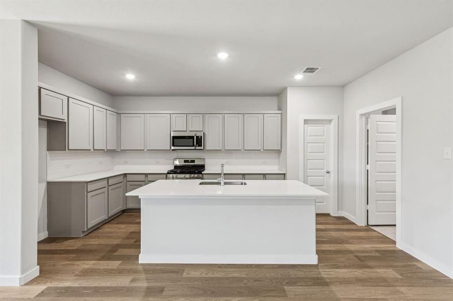 Kitchen in the Oscar home plan by Trophy Signature Homes – REPRESENTATIVE PHOTO