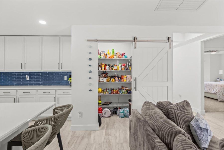 Expansive Walk-In Pantry with Decorative Sliding Barn Door Entry