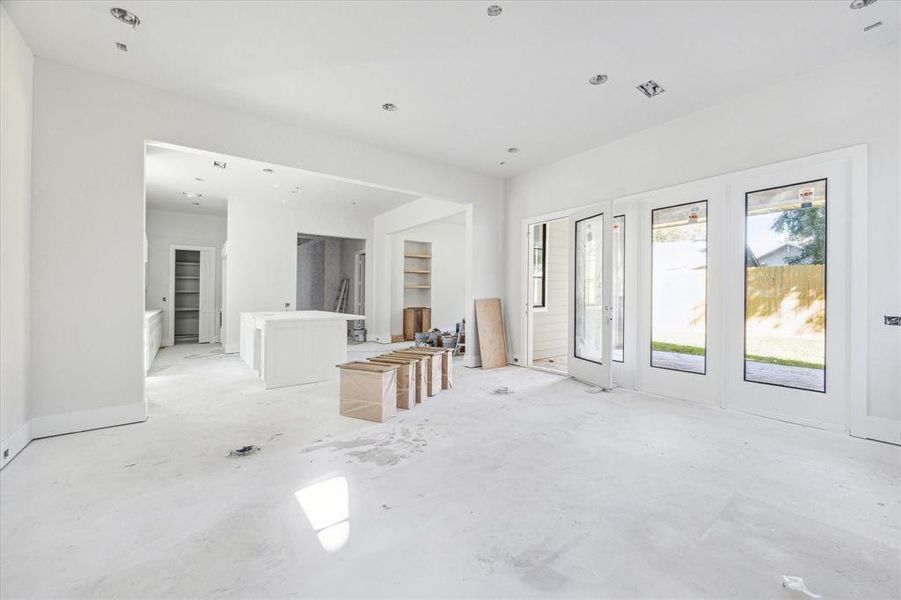 Living room with door leading to outdoor covered patio. Estimated completion date of construction - January 15, 2025.