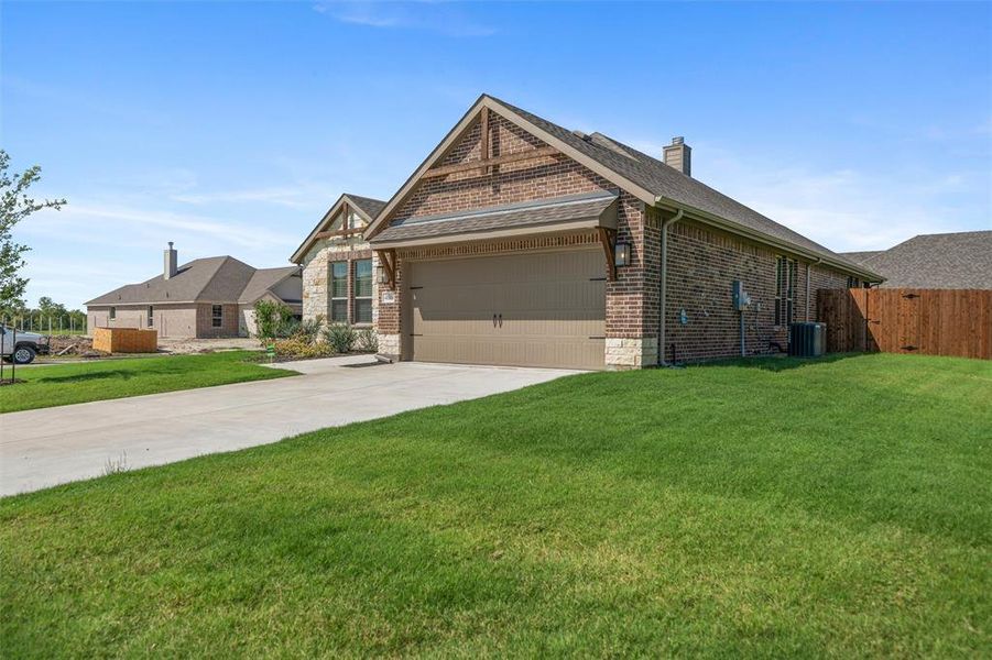Front exterior of a new home in Aero Vista, Caddo Mills, TX, highlighting curb appeal (Image 2). Front exterior of a new home in Aero Vista, Caddo Mills, TX, highlighting curb appeal (Image 2).