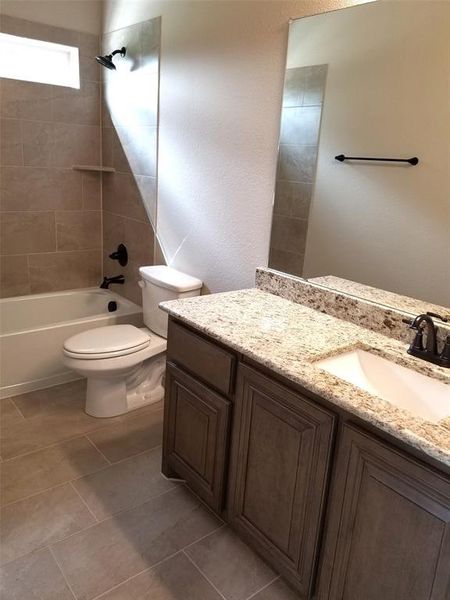 Bath 4 for Bed 5 with granite vanity and tiled tub/shower