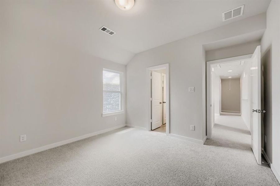 Carpeted room with neutral wall color