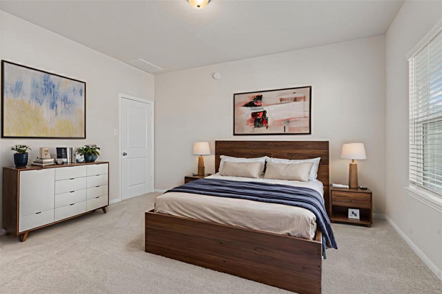 The virtually staged primary bedroom provides another elegant view of this restful space. With room for a sitting area or dresser setup, this suite combines comfort and sophistication, leading into a beautifully appointed private bath.
