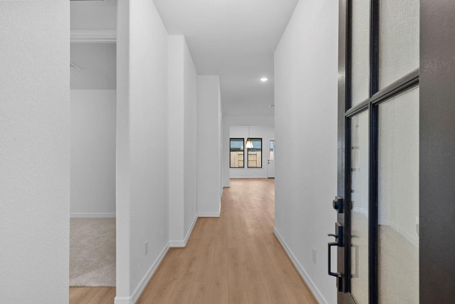 From the moment you step inside, a welcoming entryway gently guides you into the home’s open-concept living space.