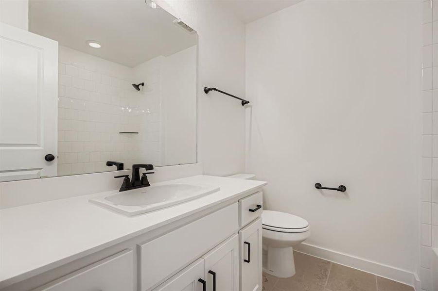 Bathroom featuring vanity and light tile patterned floors