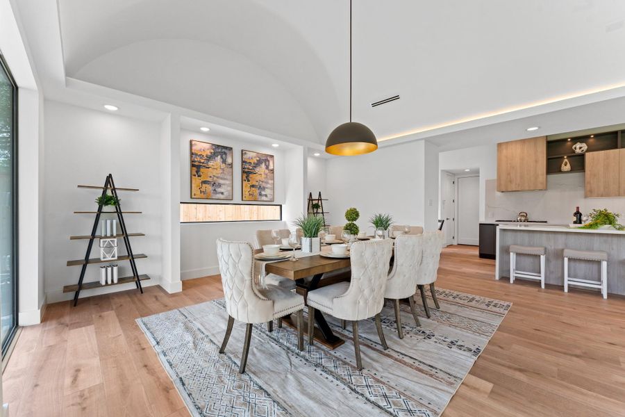 Entertain beautifully under soaring ceilings and a sculptural modern chandelier that casts a warm glow day or night.