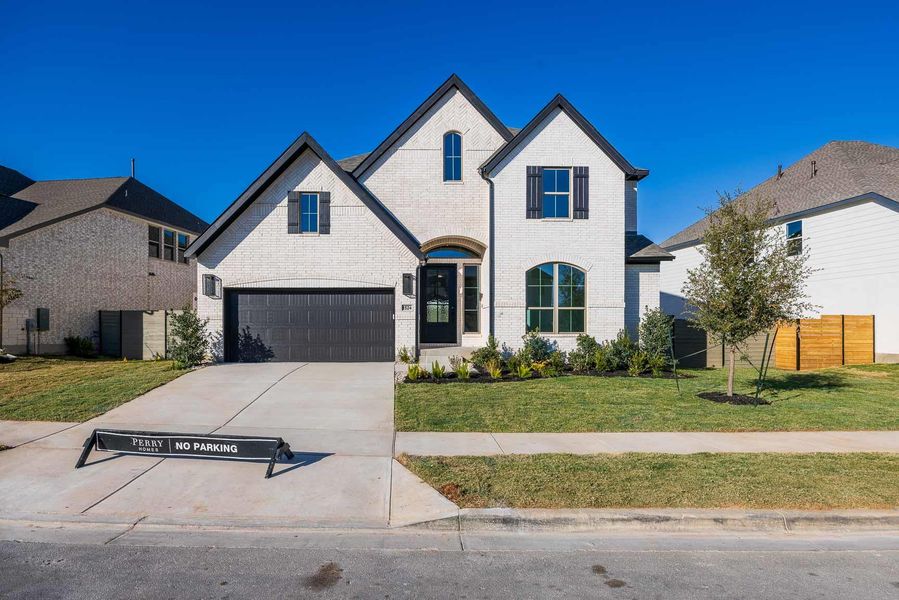 Front exterior of a new home in Wolf Ranch 56', Georgetown, TX, highlighting curb appeal (Image 20).