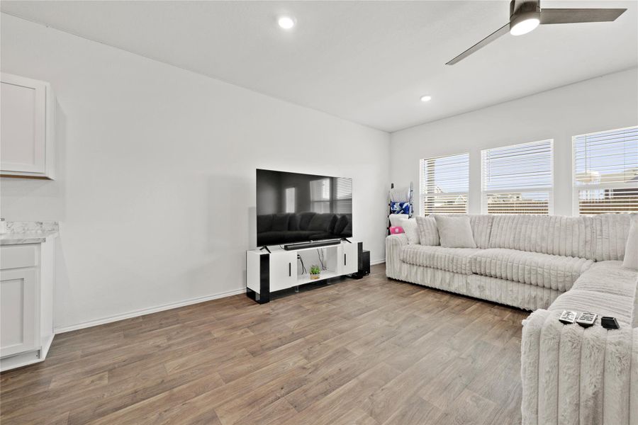 Designed for downtime or hosting! This expansive living area features a clean, modern palette and gorgeous wood-look flooring that ties the whole open-concept space together.