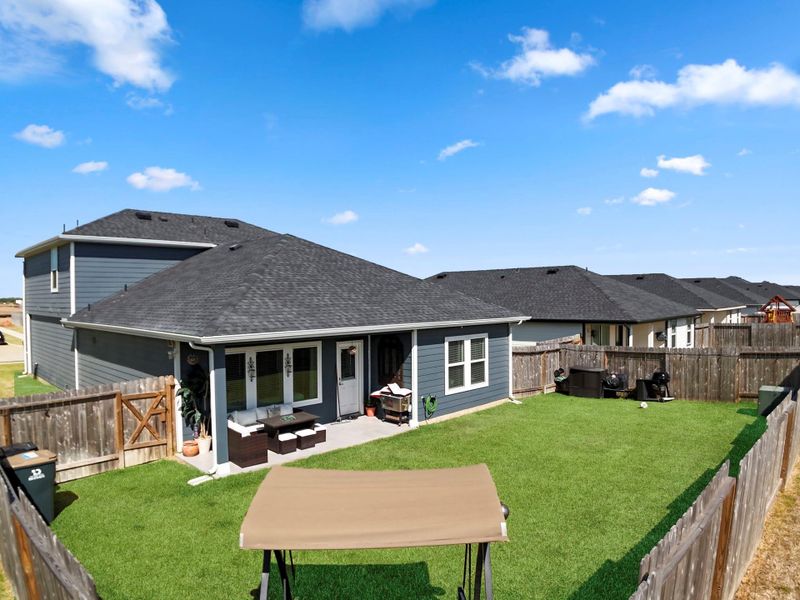 Fully fenced backyard with a covered patio—ideal for outdoor dining or weekend lounging. Fully fenced backyard with a covered patio—ideal for outdoor dining or weekend lounging.