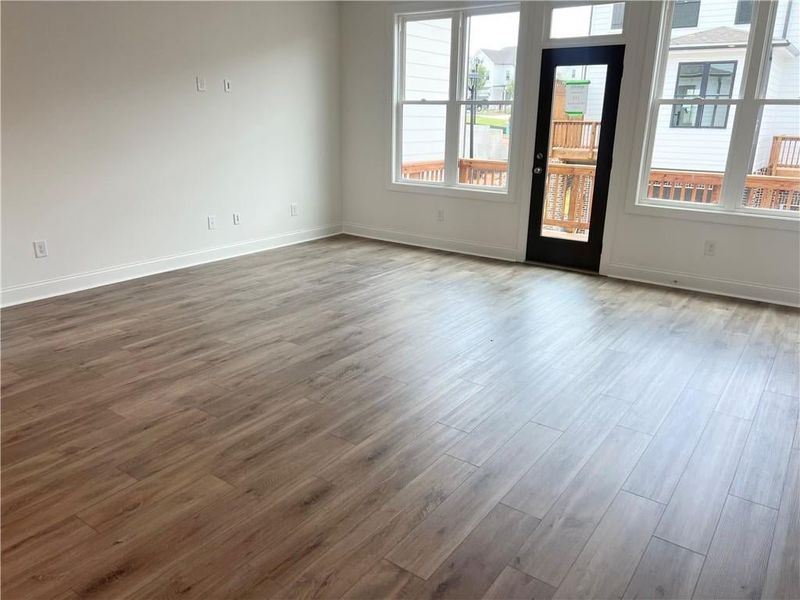 Spare room featuring dark wood-style floors