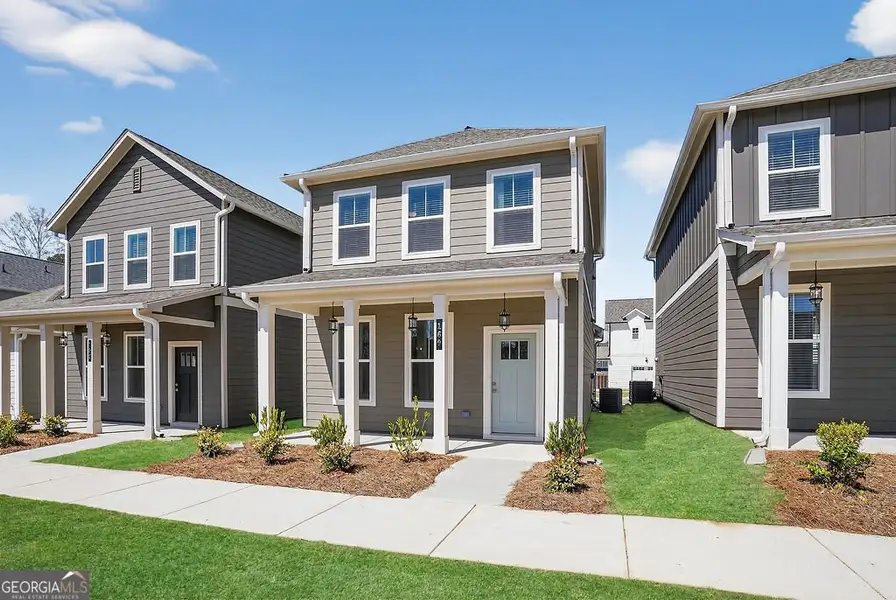 Front exterior of a new home in The Cottages at East Lanier, Fayetteville, GA, highlighting curb appeal (Image 2). Front exterior of a new home in The Cottages at East Lanier, Fayetteville, GA, highlighting curb appeal (Image 2).
