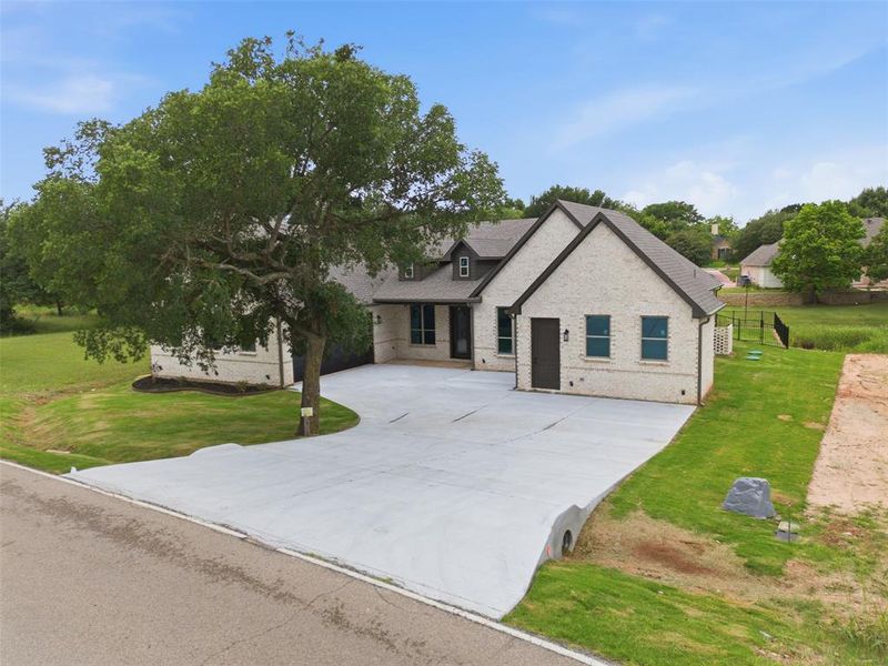 Front exterior of a new home in , Granbury, TX, highlighting curb appeal (Image 2). Front exterior of a new home in , Granbury, TX, highlighting curb appeal (Image 2).