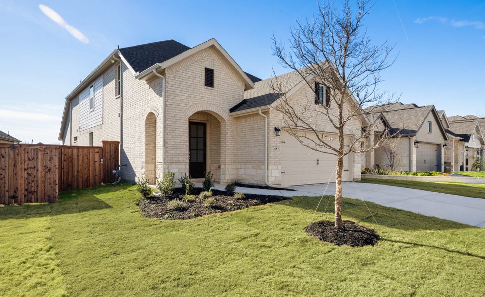 Front exterior of a new home in Reunion, Rhome, TX, highlighting curb appeal (Image 19). Front exterior of a new home in Reunion, Rhome, TX, highlighting curb appeal (Image 19).