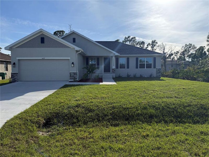 Front exterior of a new home in , Port Charlotte, FL, highlighting curb appeal (Image 1).