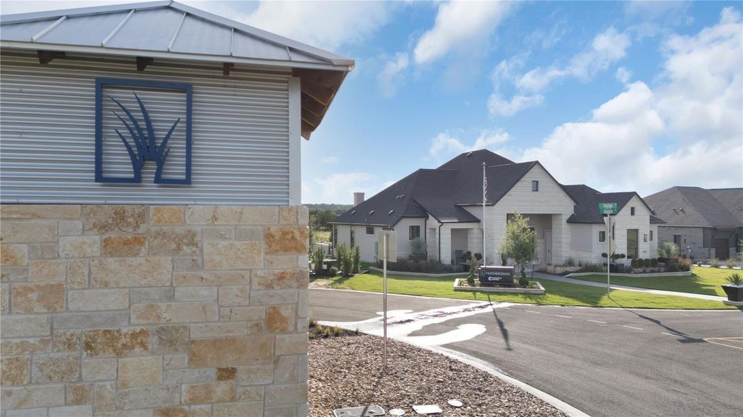 The striking stone and corrugated metal exterior of the community entrance welcomes residents and guests.