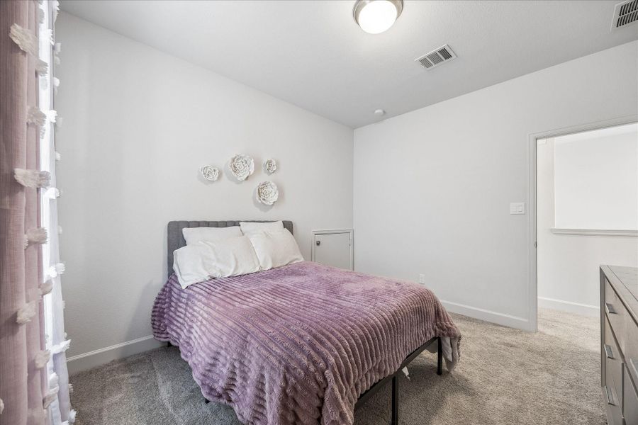 Spacious secondary bedroom featuring plush carpet, walk-in closet and abundant natural light