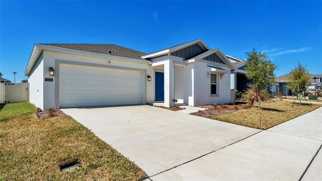 Front exterior of a new home in Ranches at Lake McLeod, Eagle Lake, FL, highlighting curb appeal (Image 21).