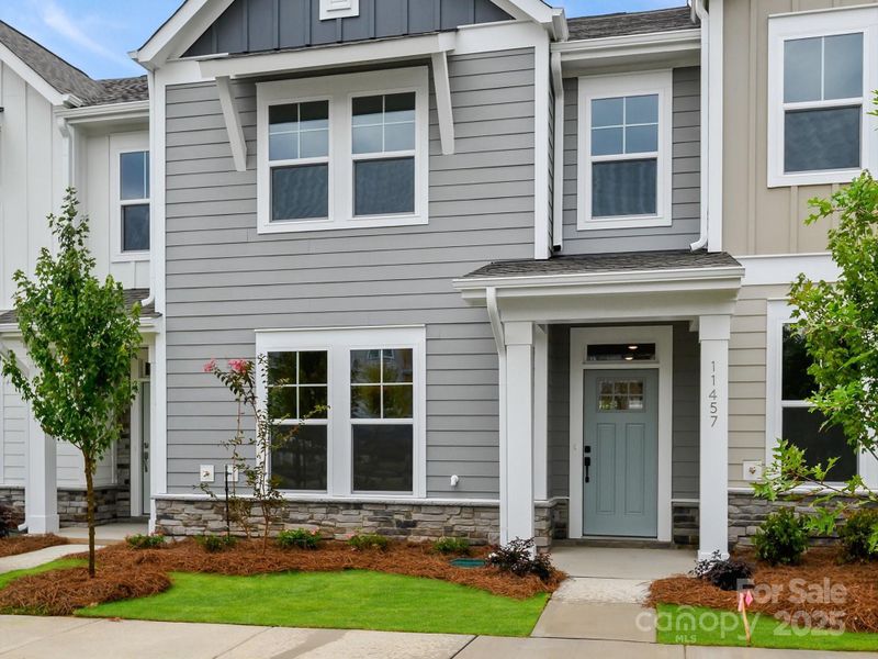 Front exterior of a new home in North Creek Village - Townhomes, Huntersville, NC, highlighting curb appeal (Image 1).