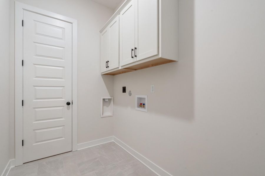 White shaker-style cabinetry with matte black hardware
