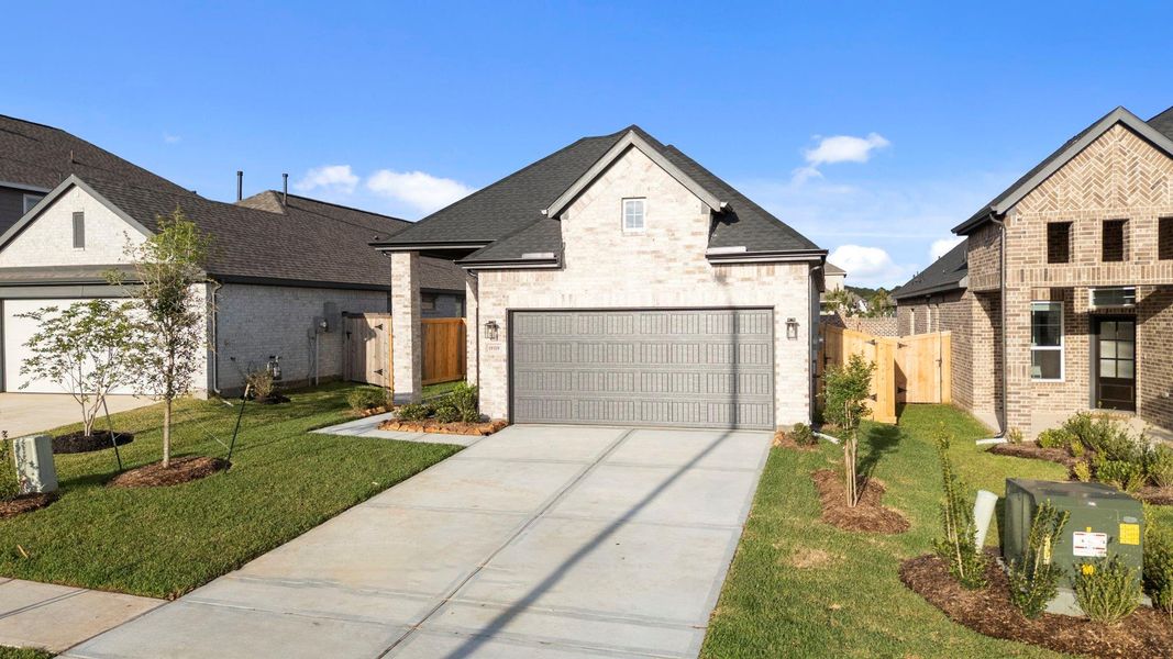 Front exterior of a new home in Emory Glen, Magnolia, TX, highlighting curb appeal (Image 17).