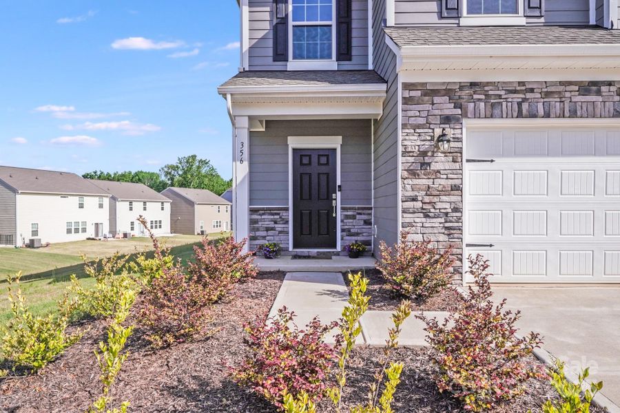 Front exterior of a new home in Elizabeth: Walk, Fort Mill, SC, highlighting curb appeal (Image 20). Front exterior of a new home in Elizabeth: Walk, Fort Mill, SC, highlighting curb appeal (Image 20).