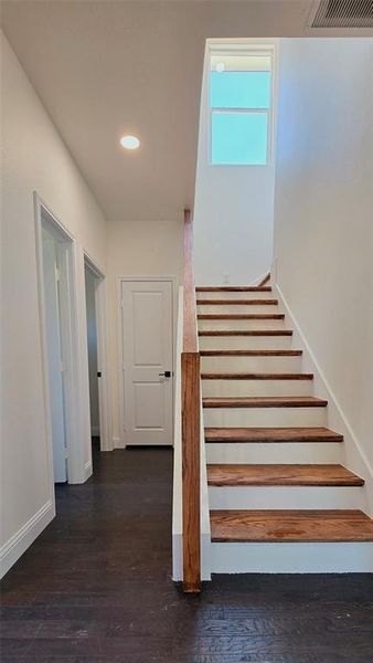 Stairs with wood finished floors and recessed lighting Stairs with wood finished floors and recessed lighting