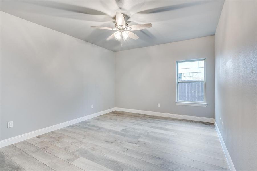 Unfurnished room with light hardwood / wood-style flooring and ceiling fan