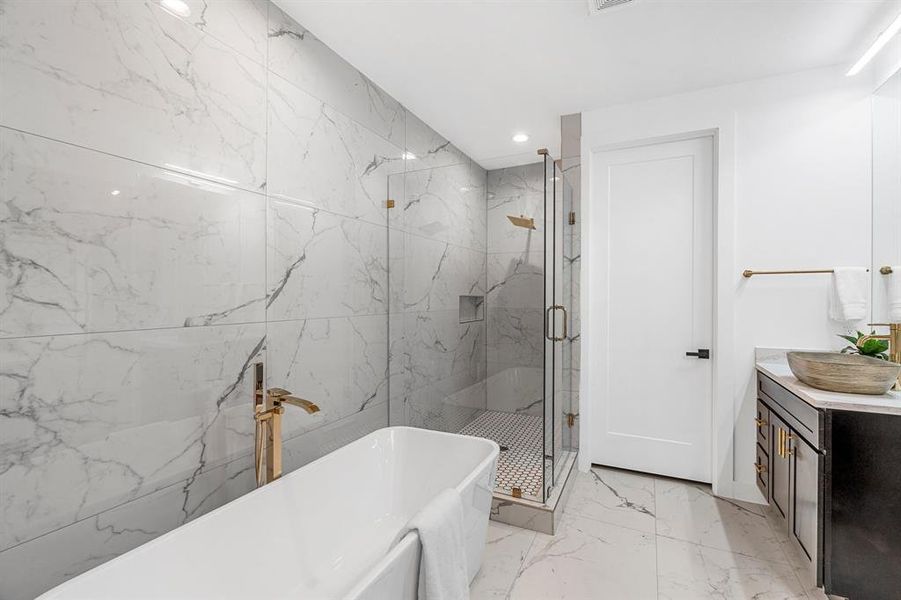 Bathroom with tile flooring, independent shower and bath, and vanity