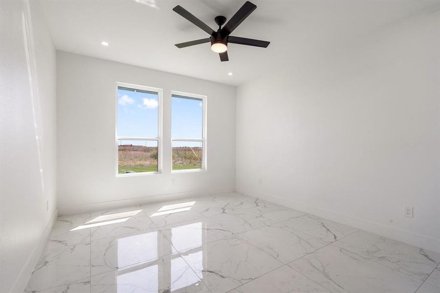 Spare room with ceiling fan