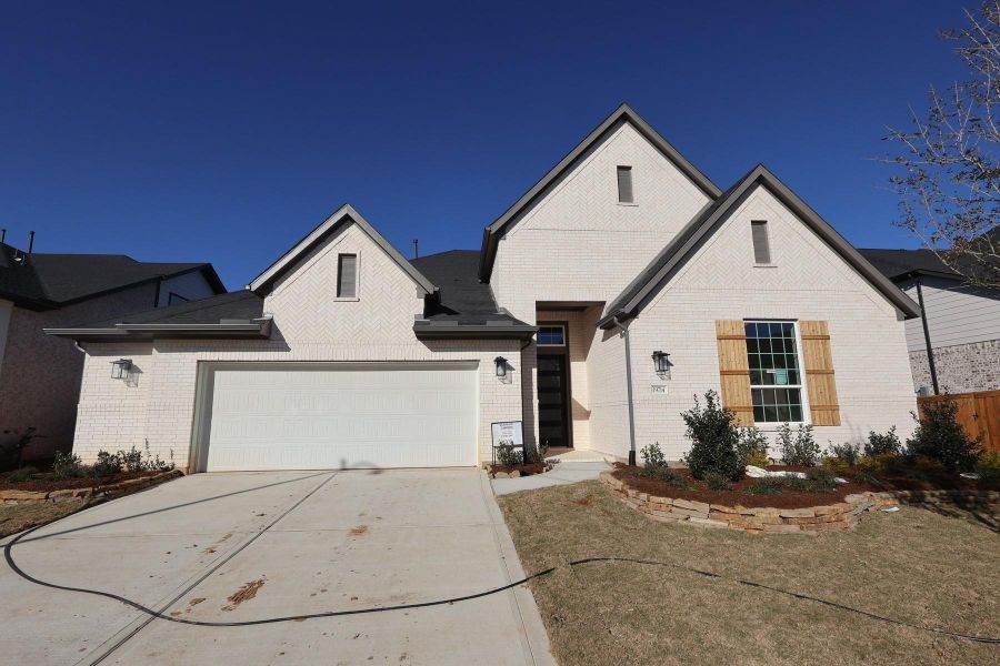 Front exterior of a new home in Dunham Pointe, Cypress, TX, highlighting curb appeal (Image 18).