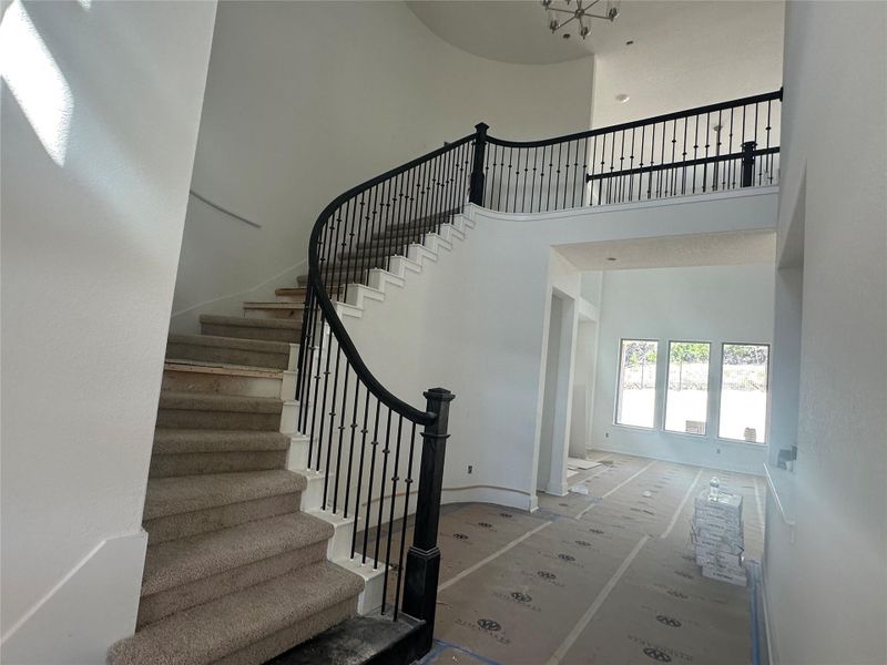 Entryway to home with soaring ceiling and grand staircase