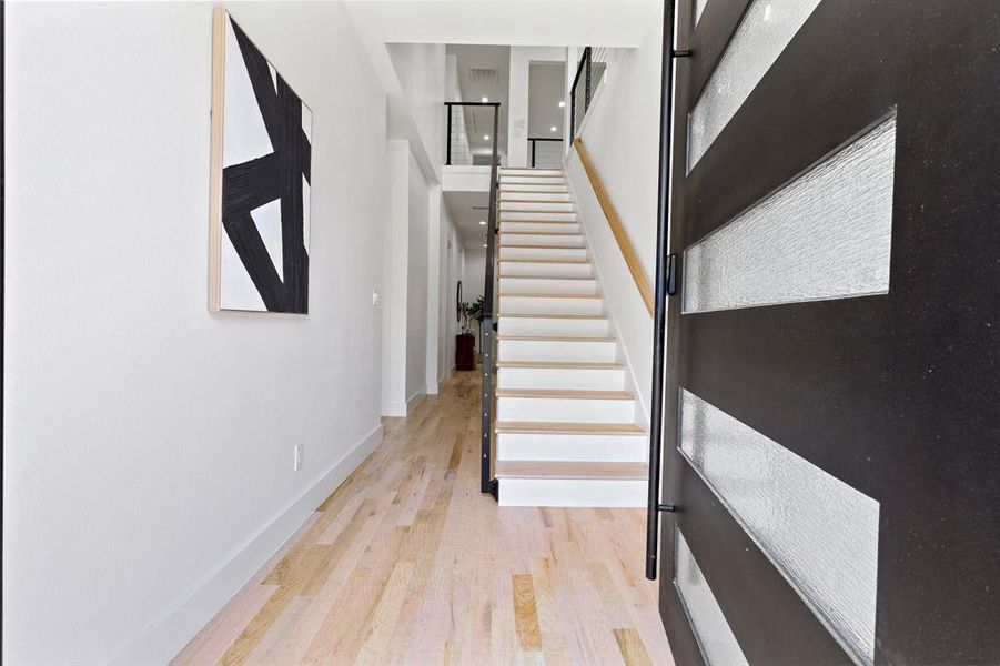 Stairs featuring hardwood / wood-style flooring