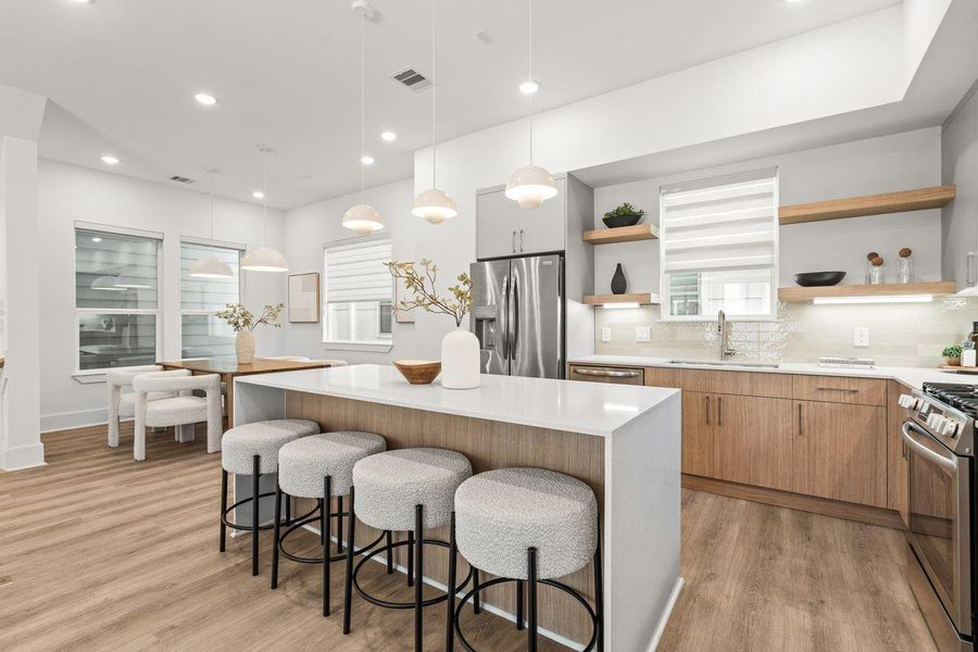 Proportional planning and intentional placement establish a balanced relationship between kitchen and dining spaces, reinforcing the home's emphasis on symmetry, flow, and connection.