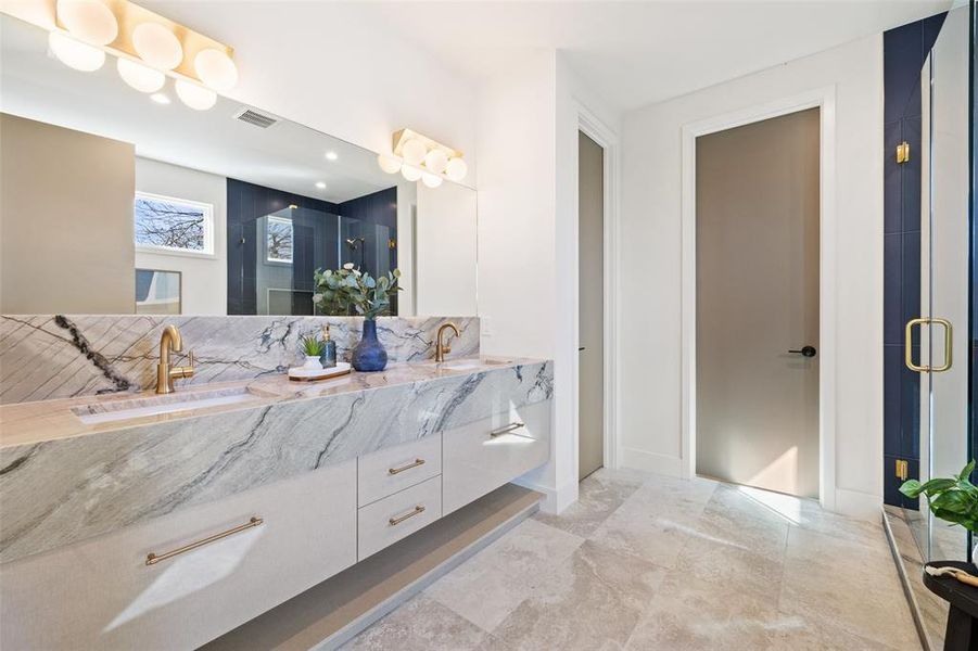 Step into luxury in the primary bathroom, a haven of sophistication featuring high-end fixtures, a spacious layout, and meticulous attention to detail.