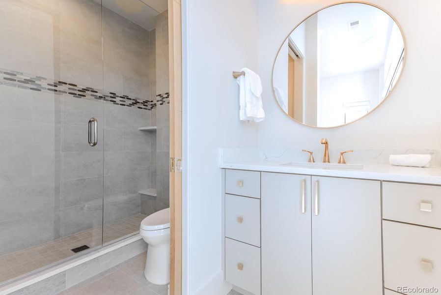 A glamorous half bath serves guests with style.