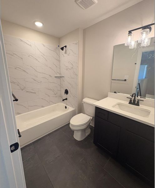 Bathroom with vanity and shower / bath combination